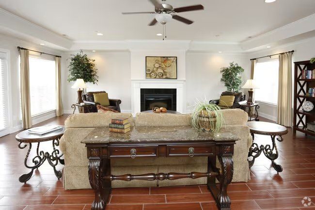 Seville Place clubhouse living room with fireplace and seating